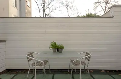 a table with two chairs and a plant on it at Amsterdam Canal Suites in Amsterdam