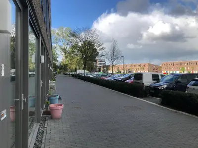 a sidewalk with cars parked in a parking lot at Studio Amsterdam in Amsterdam