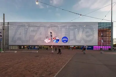 a large building with people walking in front of it at Studio Amsterdam in Amsterdam