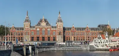 a large building next to a river with a bridge at Studio Amsterdam in Amsterdam