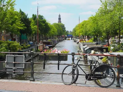 a bike parked next to a fence next to a canal at Nassau Canal Suites - in the heart of the city in Amsterdam