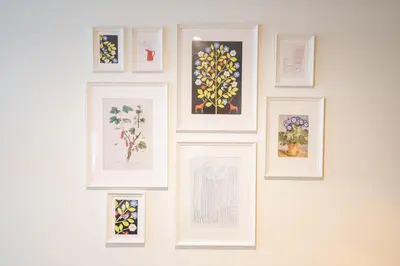 a group of framed pictures on a wall at Nassau Canal Suites - in the heart of the city in Amsterdam
