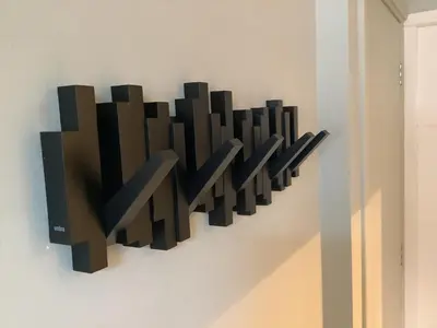 a wall art with black squares on a wall at Atelier Zonnehoek in Bergen