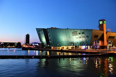 a large building next to a body of water at Vita Nova in Amsterdam