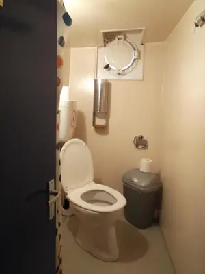a small bathroom with a toilet and a mirror at Vita Nova in Amsterdam