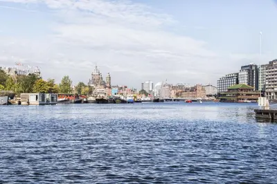a view of a river in a city with buildings at AmicitiA in Amsterdam