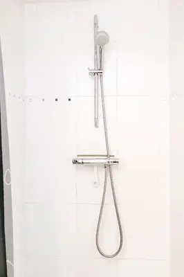 a shower with a shower head in a bathroom at Studio at Sea in Zandvoort
