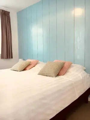 a bedroom with a bed with two pillows on it at Vakantiehuis Witsand 1 in Egmond aan Zee