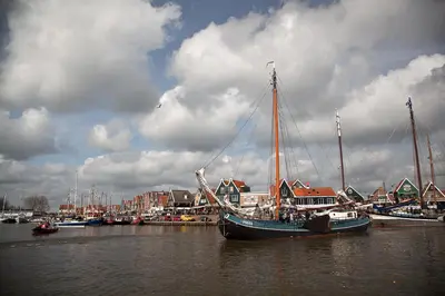 a boat is docked in a harbor with other boats at De Krasse Man in Edam