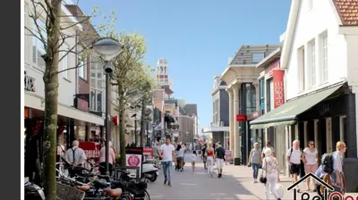 a group of people walking down a busy city street at Lodge in Noordwijk