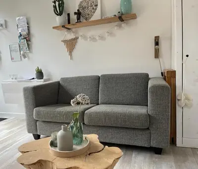 a living room with a couch and a table at Lodge in Noordwijk