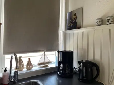a kitchen counter with a sink and a window at Me Oissie in Egmond aan Zee