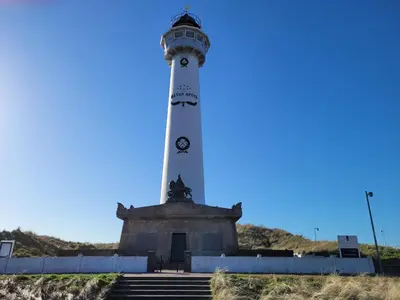 a lighthouse on the side of a hill at Sauna Cottage Egmond in Egmond aan Zee