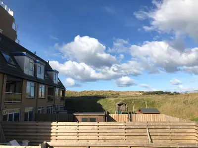a house with a playground in front of a house at Casa Nuestra in Egmond aan Zee