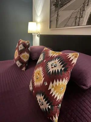 a bedroom with a bed with two pillows on it at Artist House Amsterdam in Amsterdam