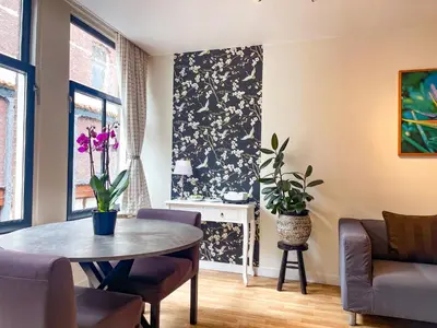a living room with a table and chairs at Artist House Amsterdam in Amsterdam