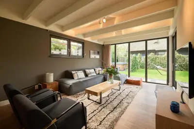 a living room with a couch and a table at Dutchen Vakantiepark Duynvoet in Schoorl