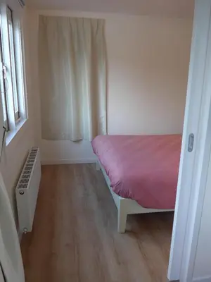 a small bedroom with a bed and a window at Houseboat In The Center, 5 min walk to Tropical Museum, Free Wifi! in Amsterdam
