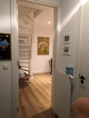 a hallway with an open door to a room at Appartement 4 Seasons Katwijk aan Zee in Katwijk aan Zee