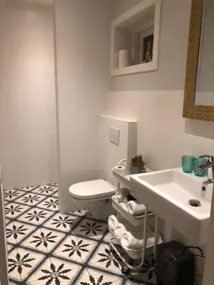 a bathroom with a toilet and a sink at Appartement 4 Seasons Katwijk aan Zee in Katwijk aan Zee