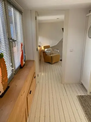 a living room with a couch and a chair at Appartement 4 Seasons Katwijk aan Zee in Katwijk aan Zee