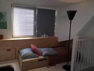 a bedroom with a bed with two pillows and a window at Appartement 4 Seasons Katwijk aan Zee in Katwijk aan Zee