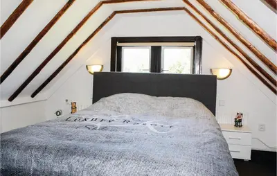 a bedroom with a bed and a window at Hoeve Alegria in Hoogwoud