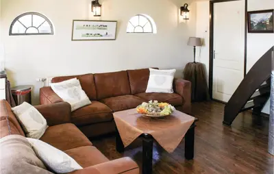 a living room with a couch and a table at Hoeve Alegria in Hoogwoud