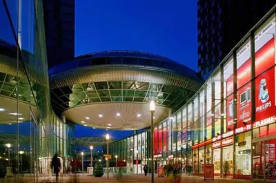 a building with a curved ceiling in a city at night at Zoetermeer City Center Loft Apartment in Zoetermeer