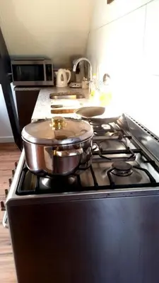 a stove top with two pots on top of it at Zoetermeer City Center Loft Apartment in Zoetermeer