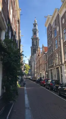 a city street with a clock tower in the distance at The Blossom House Amsterdam in Amsterdam