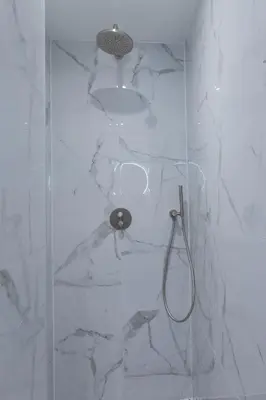 a bathroom with a shower with a glass door at The Blossom House Amsterdam in Amsterdam