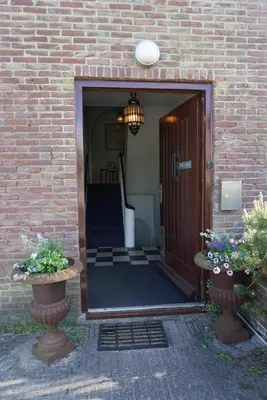 a entrance to a brick building with a door at villa Flore, studio's in Bergen aan Zee