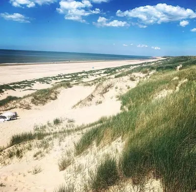 a view of a sandy beach with the ocean at villa Flore, studio's in Bergen aan Zee