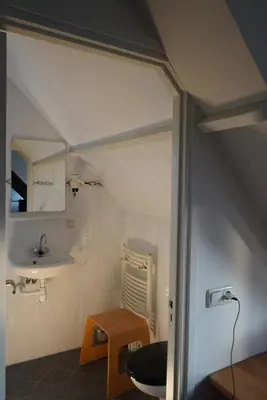 a small bathroom with a sink and a toilet at villa Flore, studio's in Bergen aan Zee