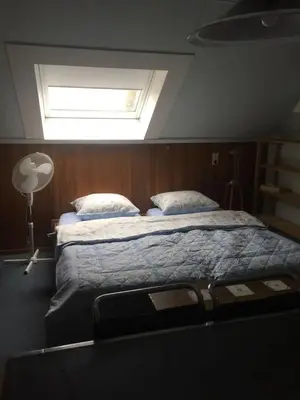a bedroom with a large bed with a window at Cozy room in residential Alkmaar - Free parking in Alkmaar