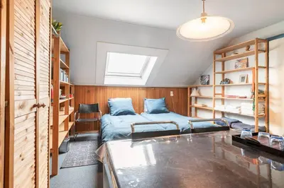 a bedroom with a bed and bookshelves at Cozy room in residential Alkmaar - Free parking in Alkmaar