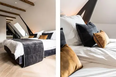 a bedroom with a bed with black and white pillows at de Vogelensangh in Vogelenzang