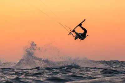a person is in the air over the ocean at Hotel Neptunus in Egmond aan Zee