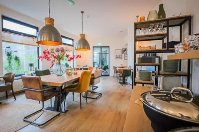 a dining room with a table and chairs at Hotel Neptunus in Egmond aan Zee