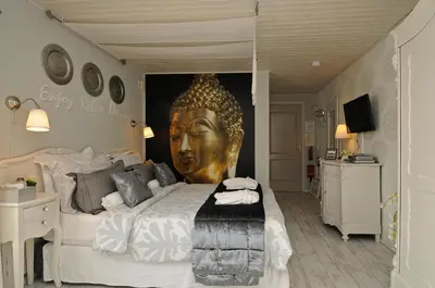a bedroom with a bed with a large head on the wall at B&B de Valkenhorst in Lelystad