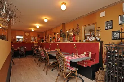 a restaurant with a table and chairs in a room at B&B de Valkenhorst in Lelystad