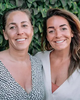 two women are standing next to each other at Pension Corper in Zandvoort