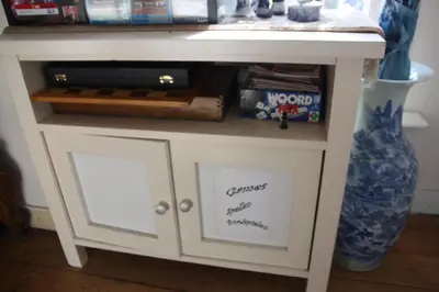 a small white table with a drawer and a shelf at Pension Corper in Zandvoort