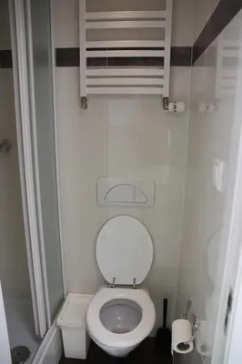 a small bathroom with a white toilet in a room at Pension Corper in Zandvoort