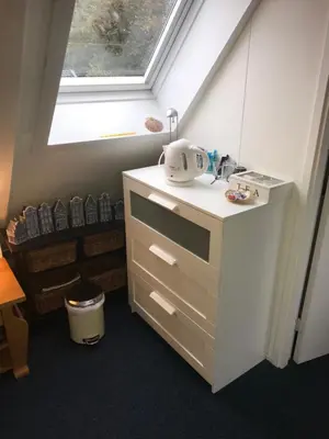 a small kitchen with a sink and a window at B&B De Duinhoek in Beverwijk
