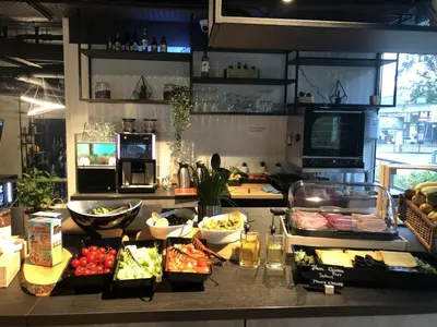 a kitchen with fruits and vegetables on a counter at Hotel New Kit in Amsterdam