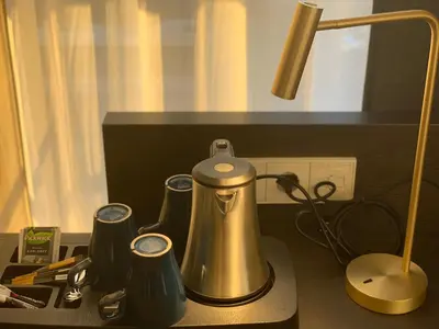 a coffee maker sitting on a counter next to a lamp at Hotel New Kit in Amsterdam