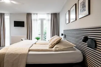 a bedroom with a large bed and a window at de Logerie in Enkhuizen