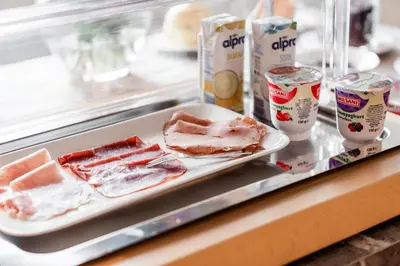 a plate of food on a counter with meat and yogurt at de Logerie in Enkhuizen